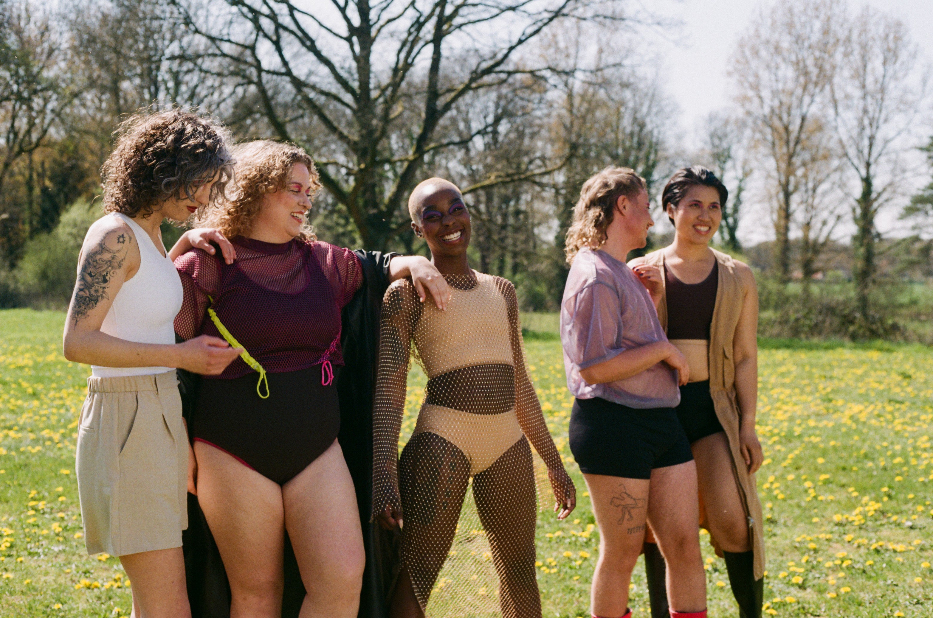 a happy group photo that we took during our gender neutral and gender inclusive photoshoot. the models are wearing chest binders, tucking underwear, packers, and other gender affirming items