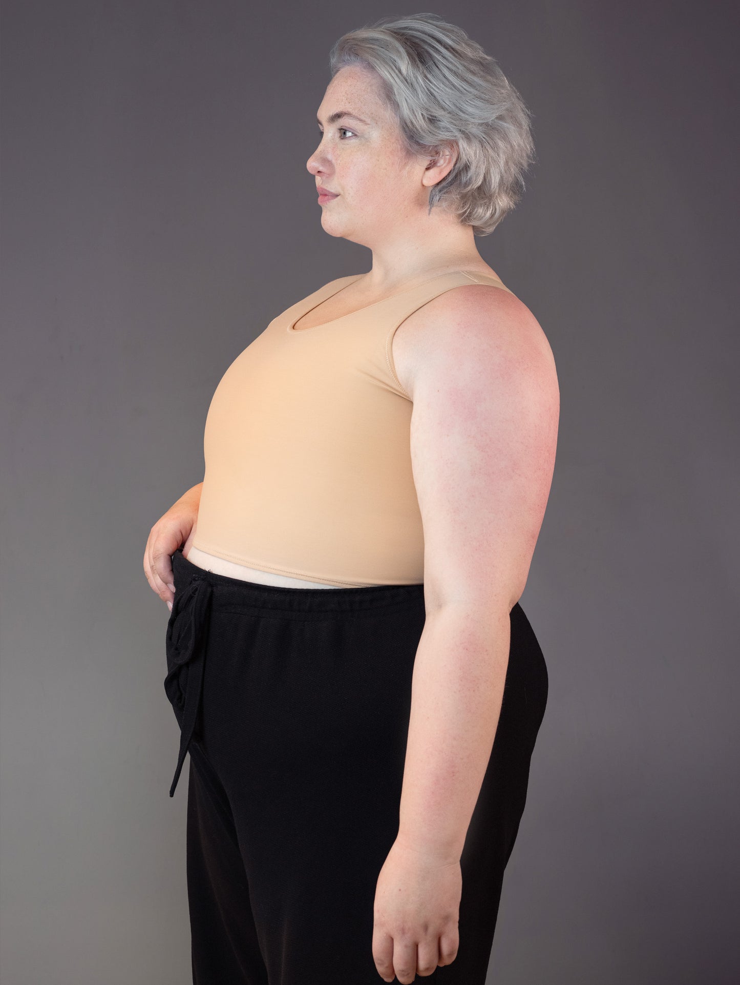 3/4 view of the UNTAG Short Binder, modeled by Jeannette