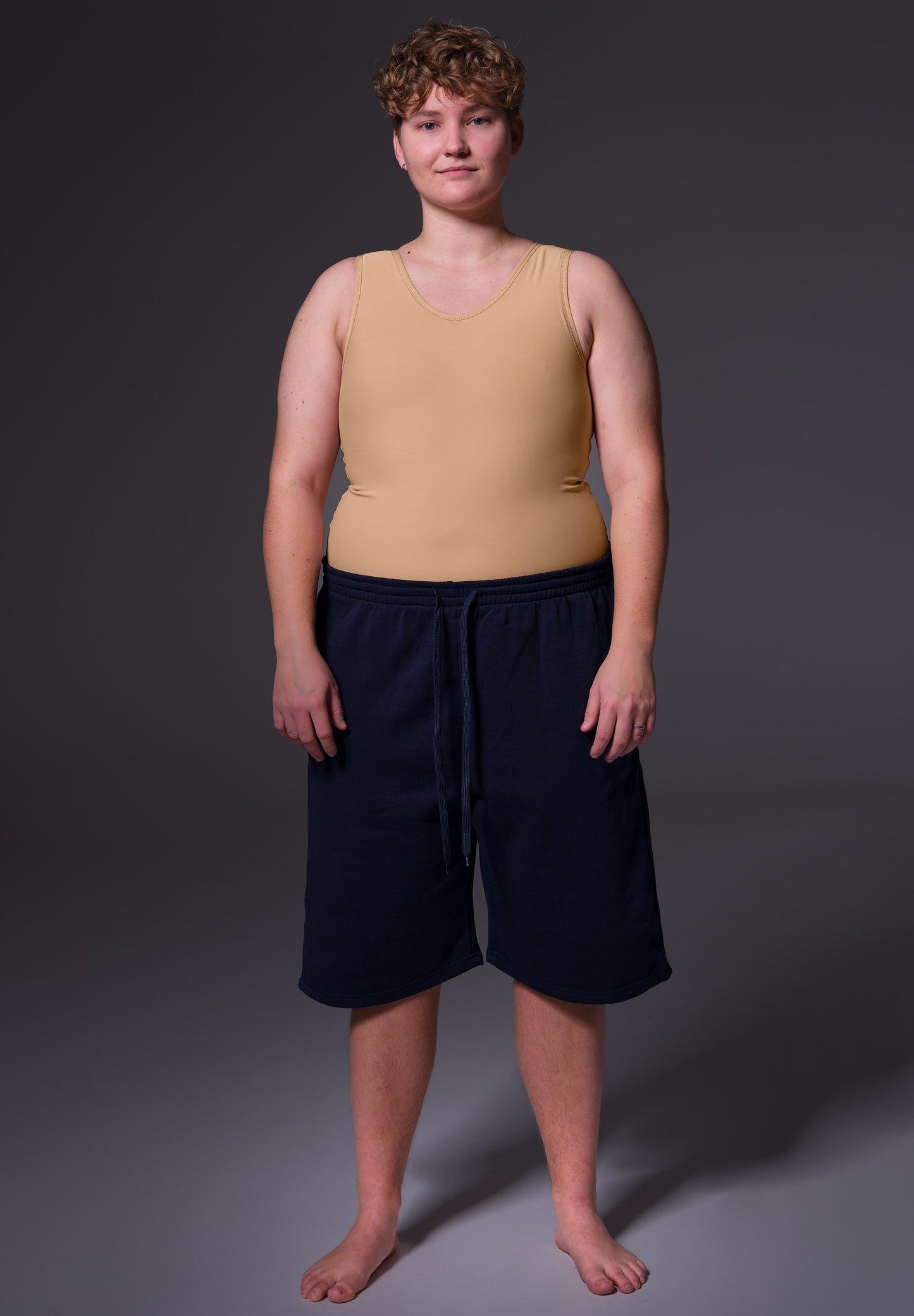 Front view of Deven wearing the Shirt Binder caramel