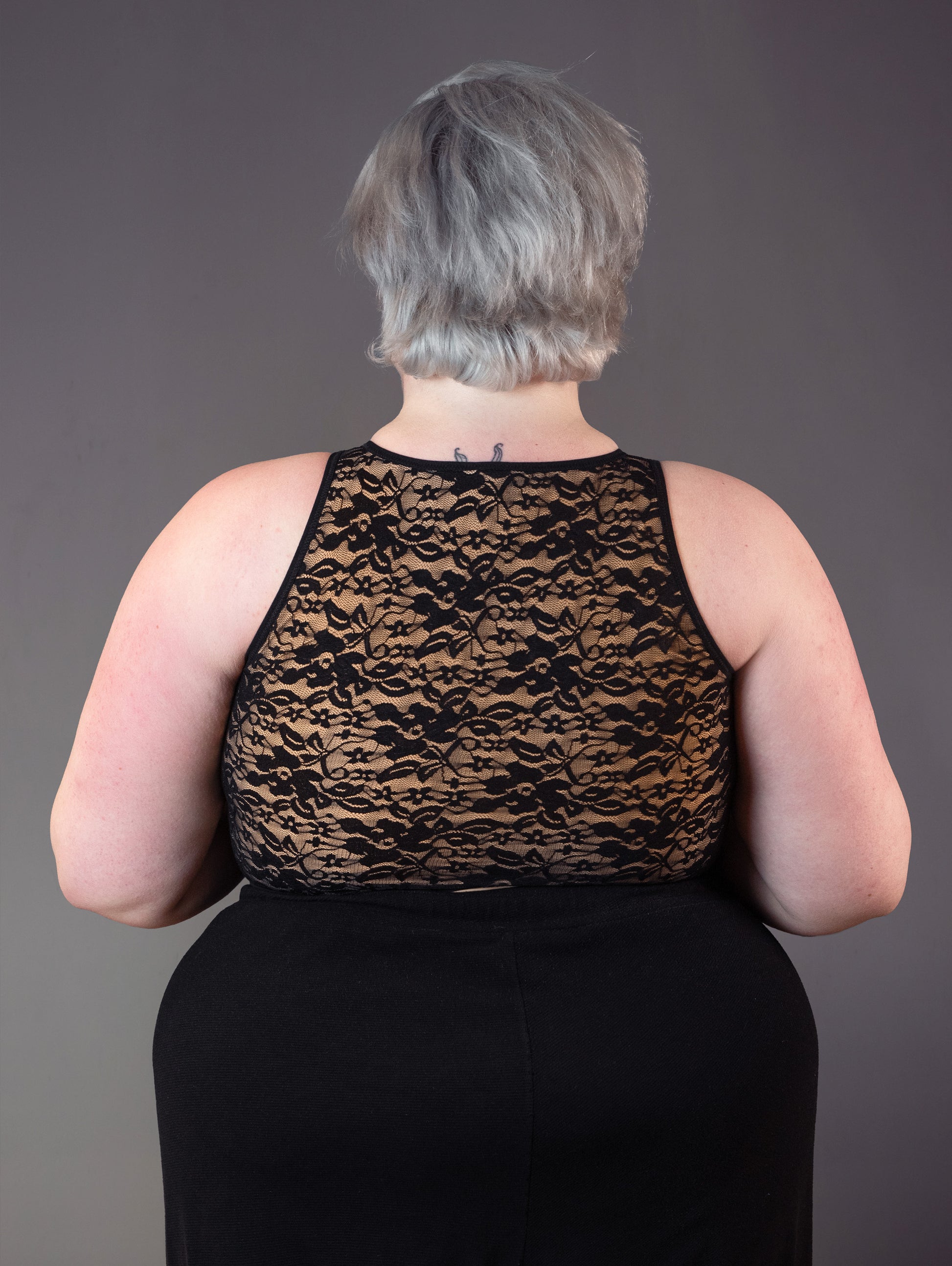 Jeannette wears the lace binder, as seen from the back..