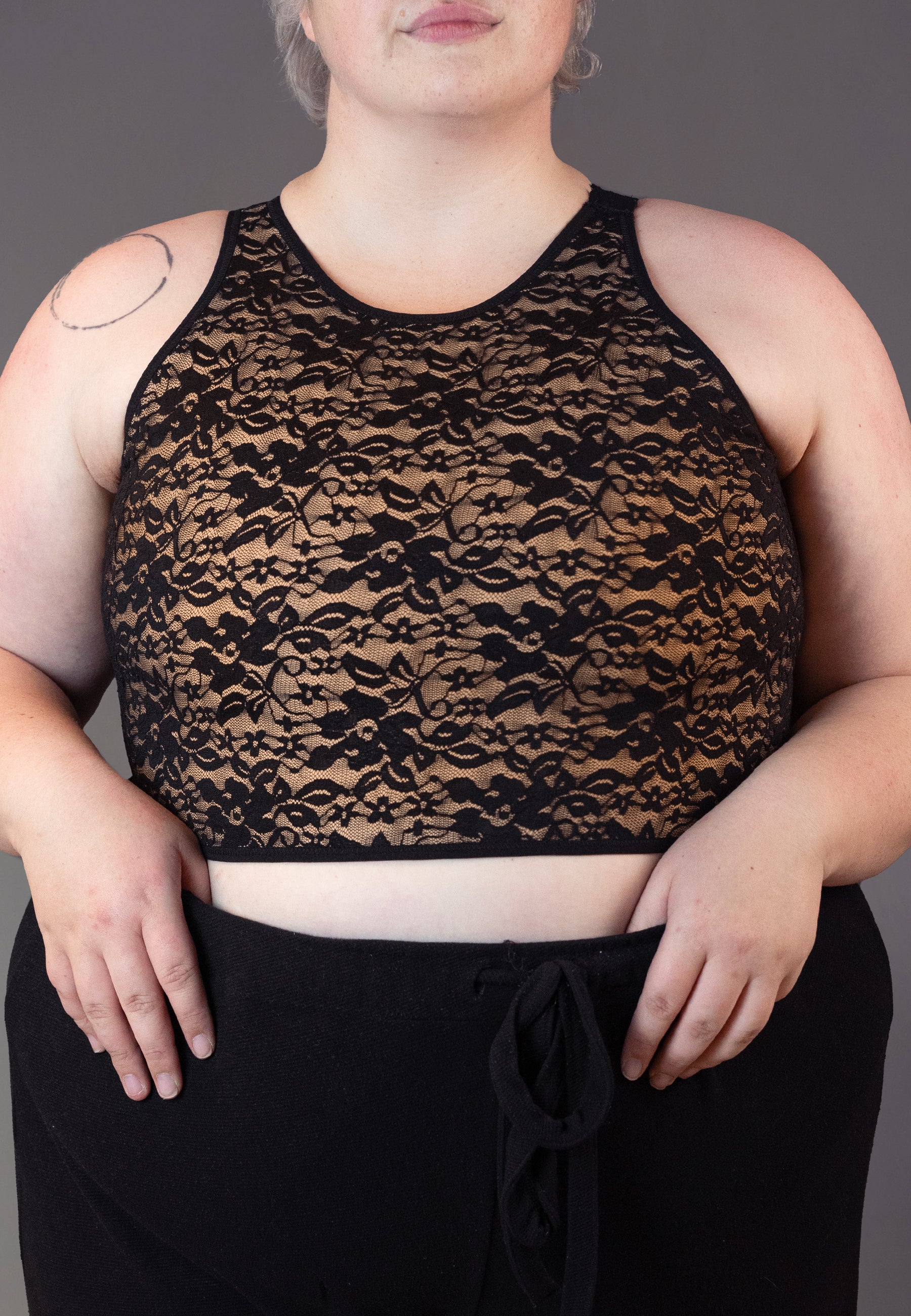 Festive lace binder worn by genderqueer model Jeannette