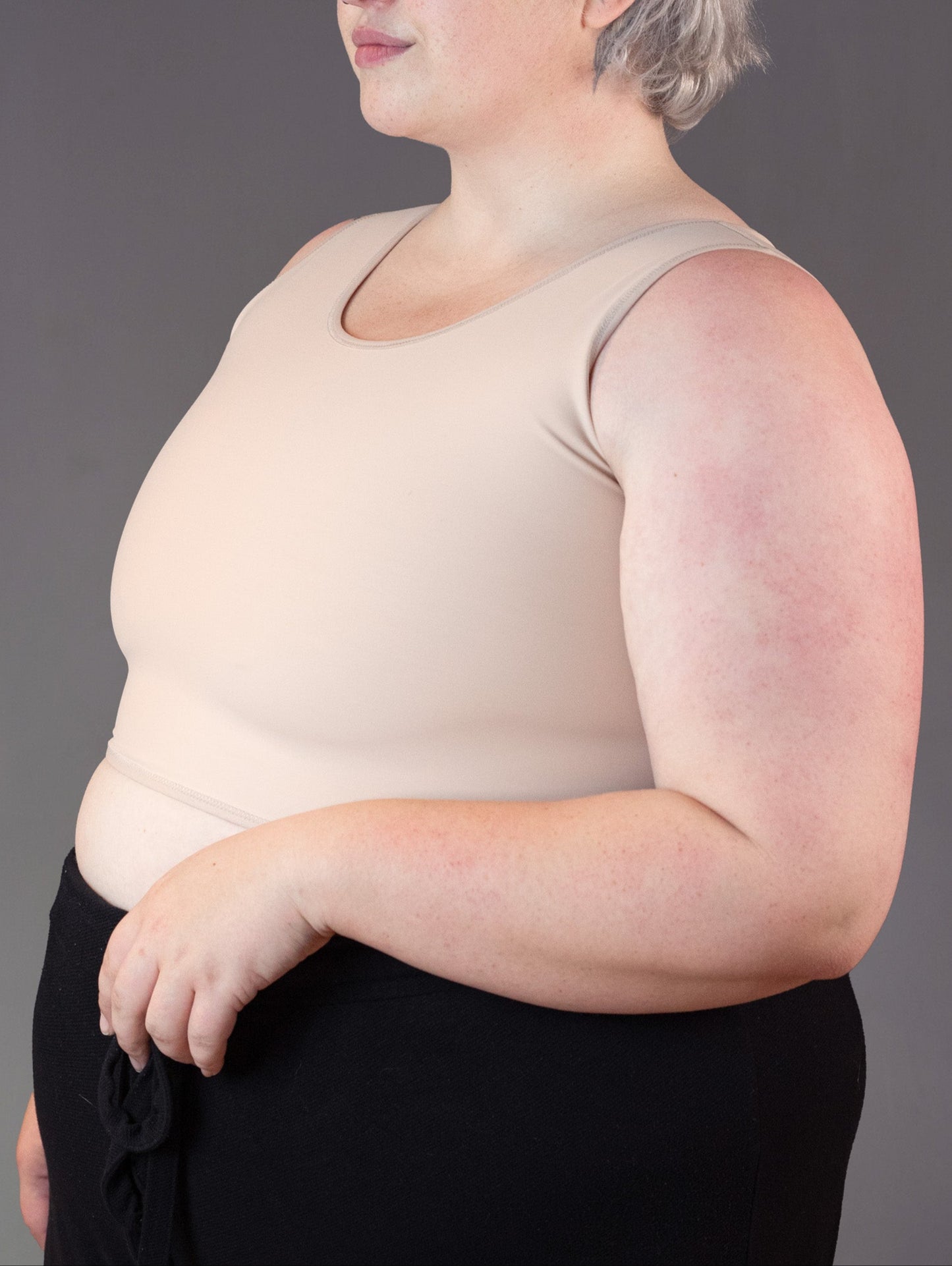 Beige colored short binder worn by short-haired model