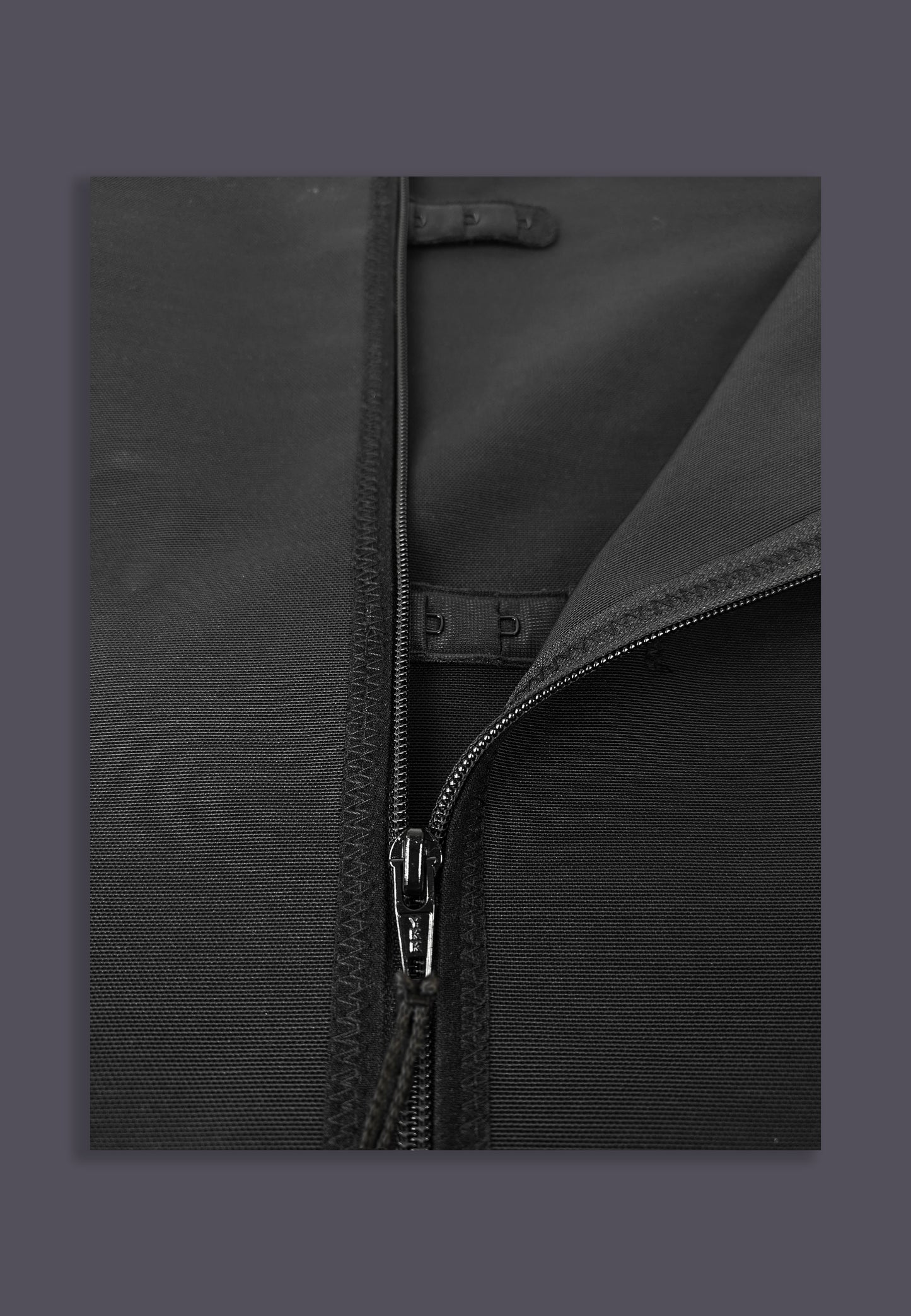 Singlet Binder Zipper black close-up of the zipper and hook and eye fastenings