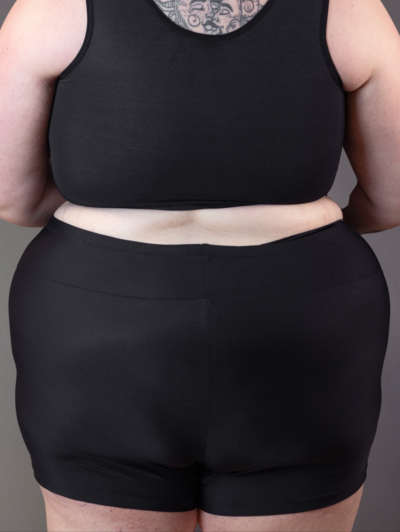 Gender affirming swimming shorts as seen from the back on plus size model Jeannette.