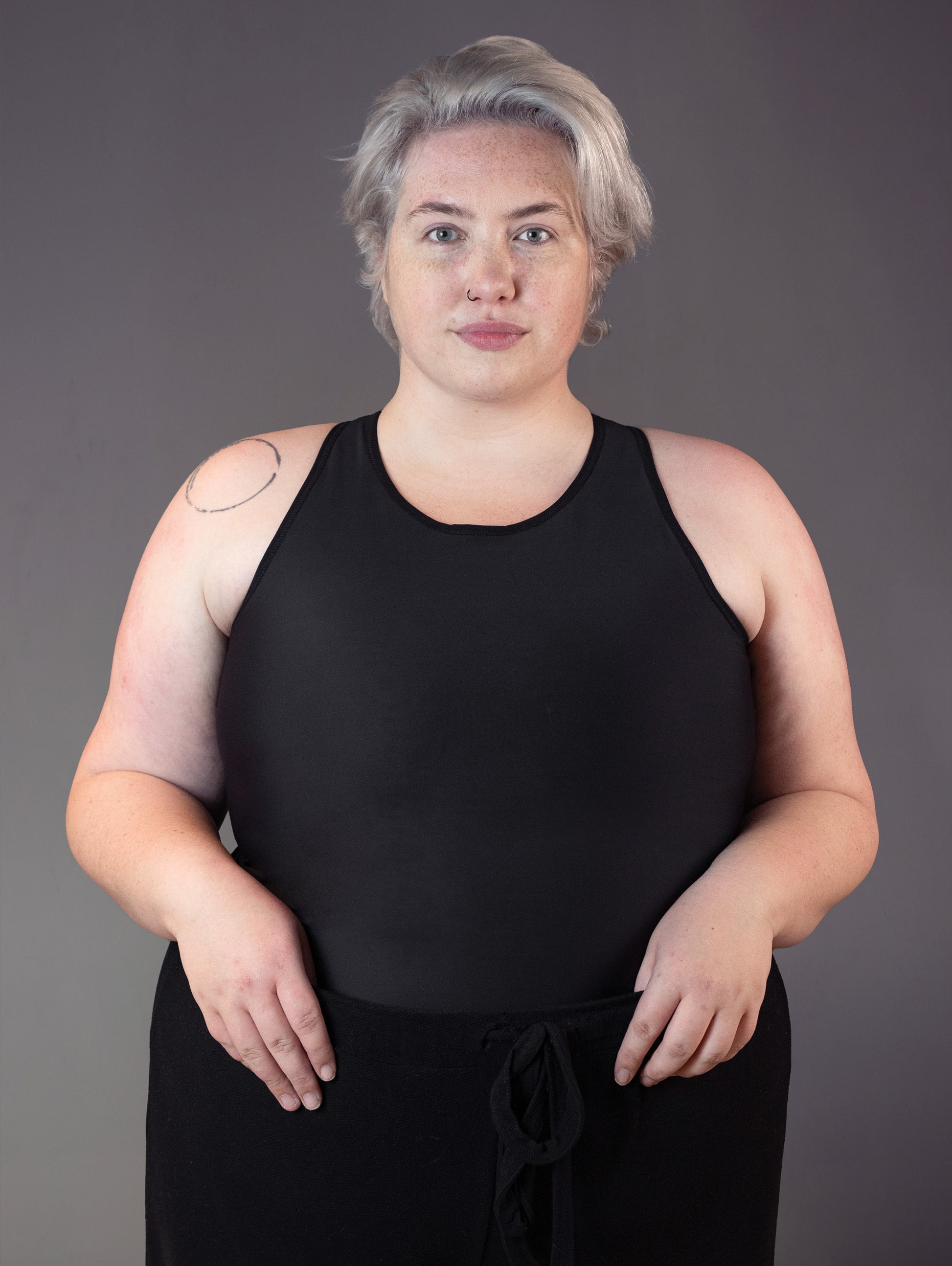 Front view of nonbinary model Jeannette wearing our Tank Shirt Binder