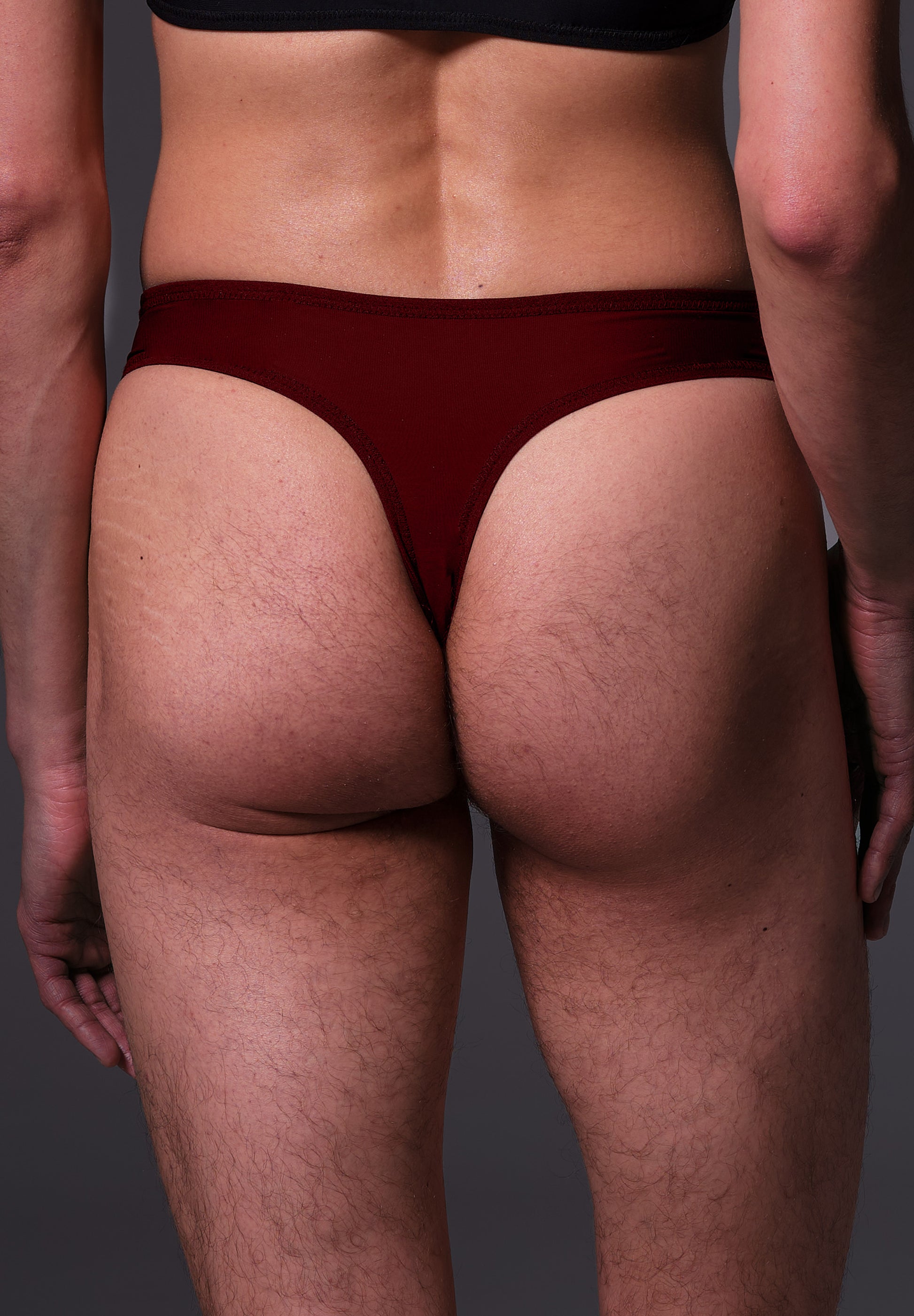 UNTAG MtF trans femme tucking thong extra strong burgundy red model back close up 