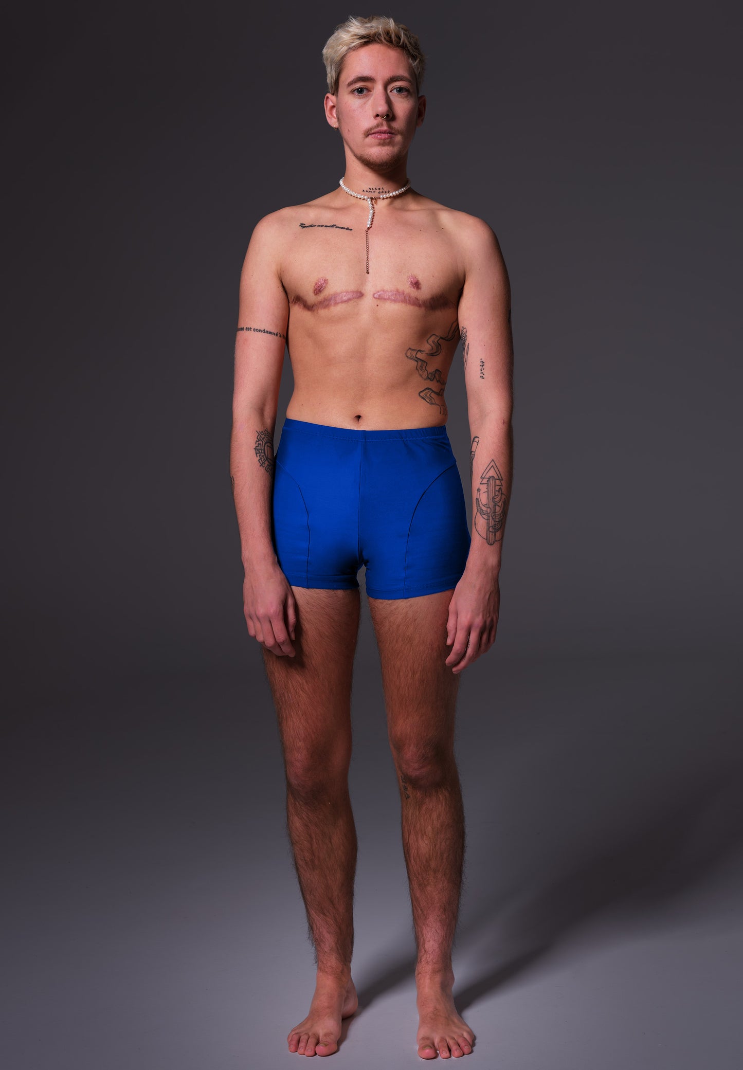 UNTAG FtM trans masc non binary swim cobalt blue swim shorts packing model front 3