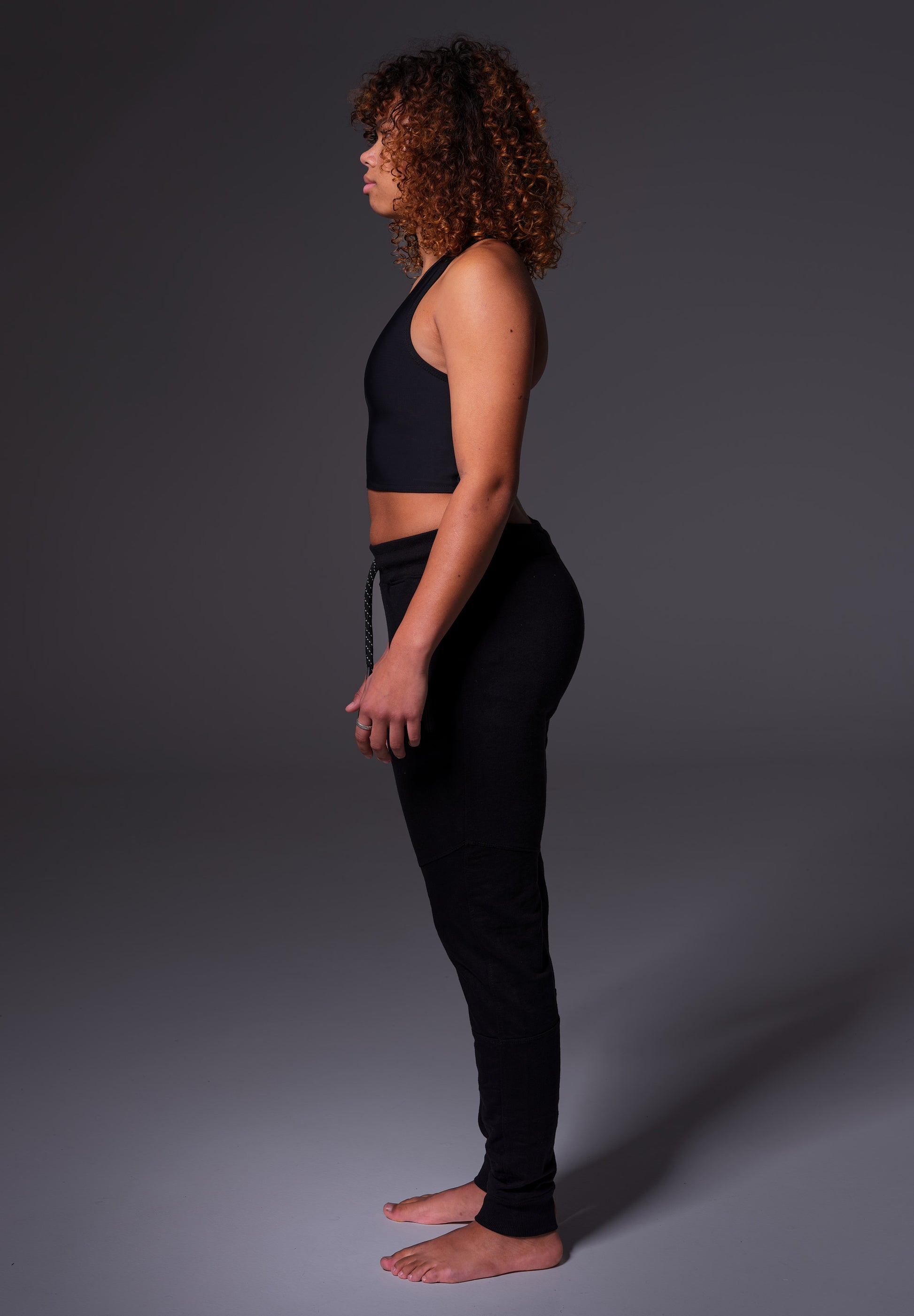 Side view of the Tank Binder in black, worn by Loraine
