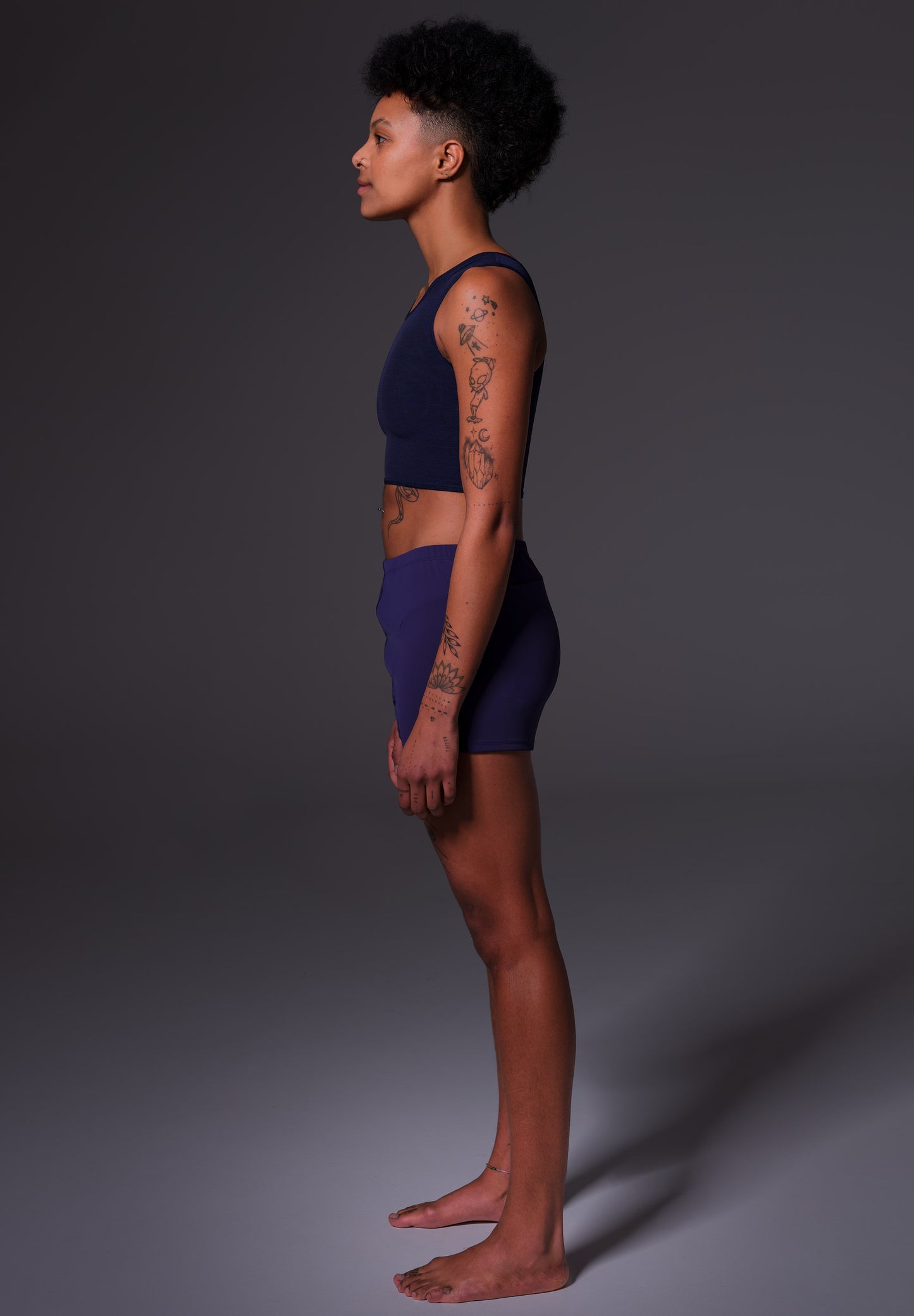 Side view of the Swim Shorts dark blue worn by model KC