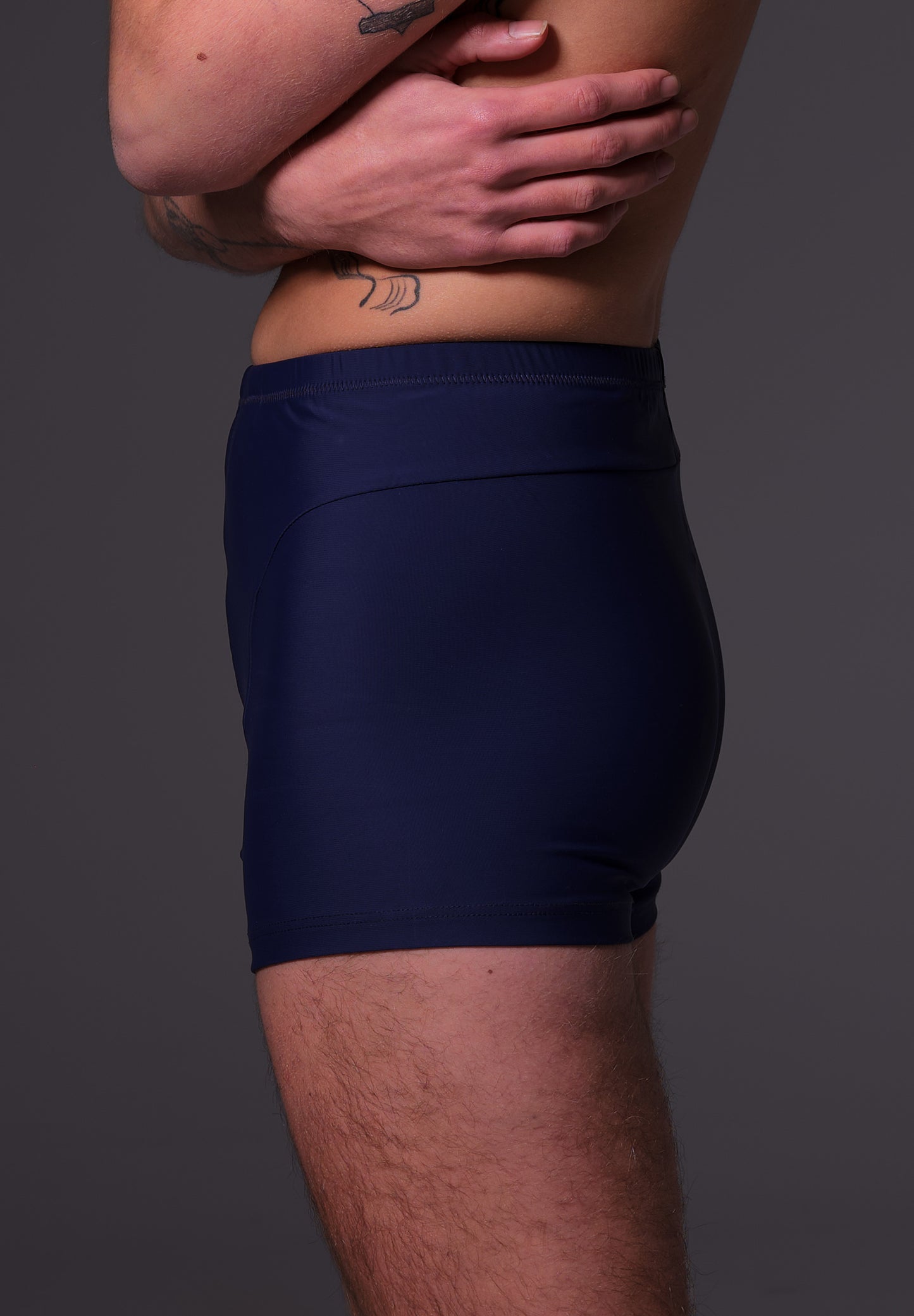 Side close-up of Mees wearing the Swim Shorts dark blue