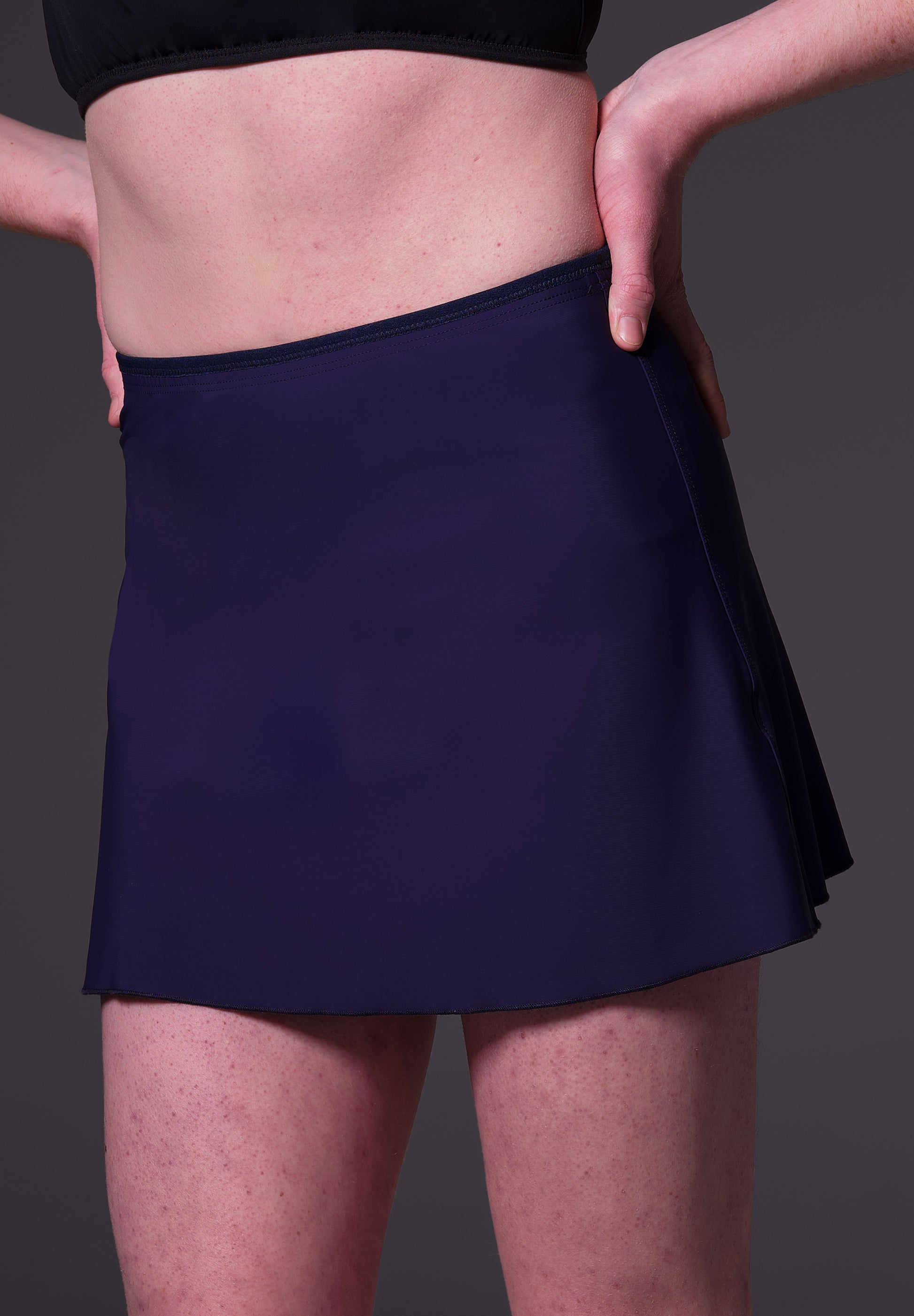 Front close-up of model Sweder, wearing the Swim Skirt dark blue, by UNTAG