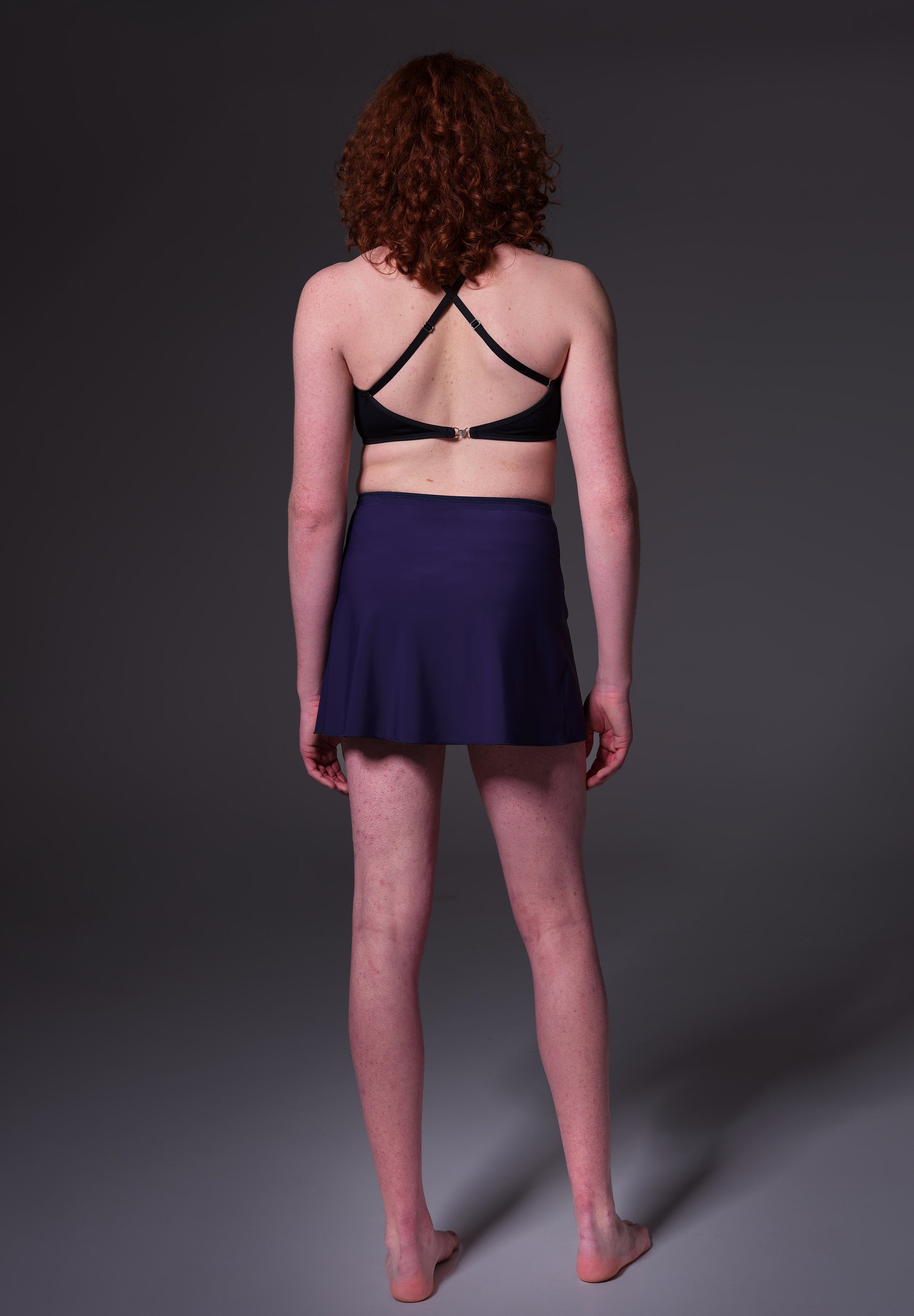 Swim Skirt dark blue, seen from the back and worn by model Sweder