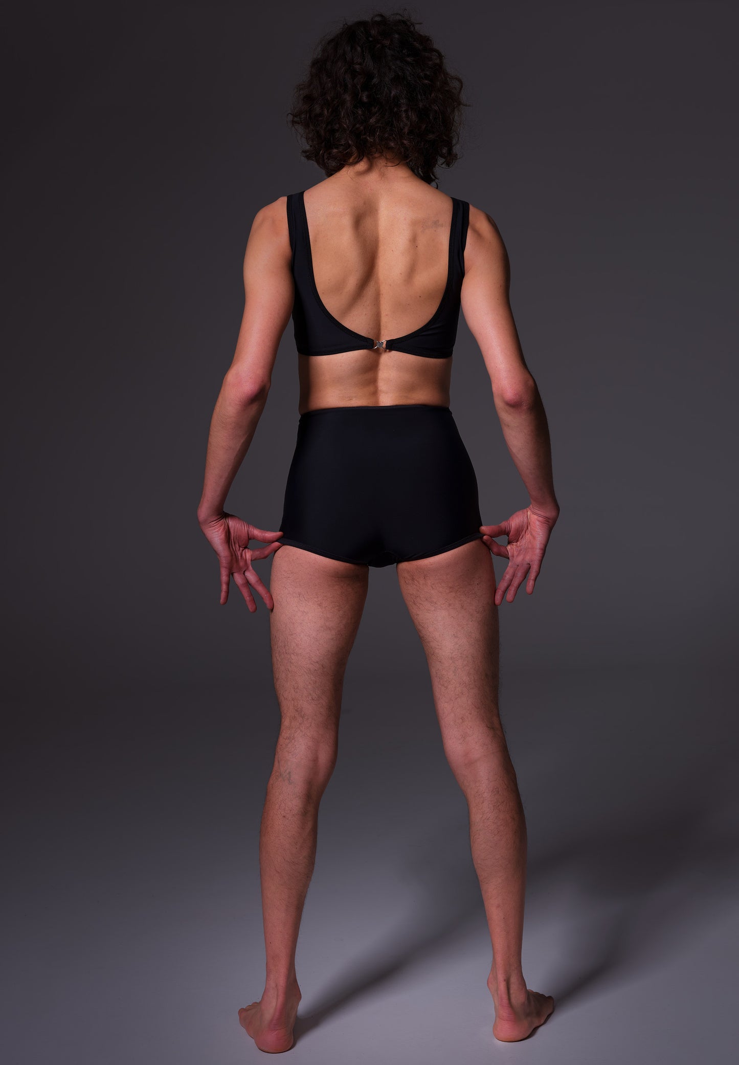 Bikinitop in black, back view when worn by model Riah
