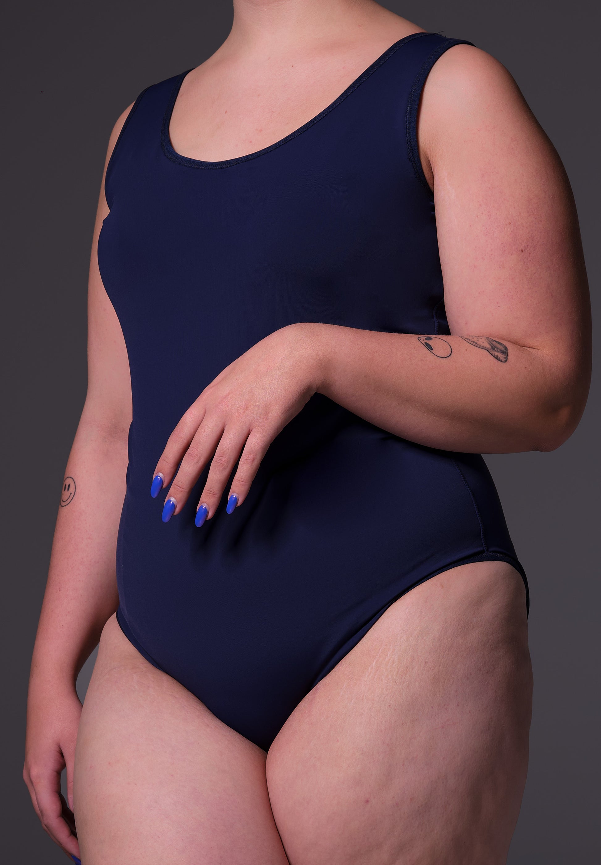 Front close-up of Sasha wearing the Swimsuit in dark blue