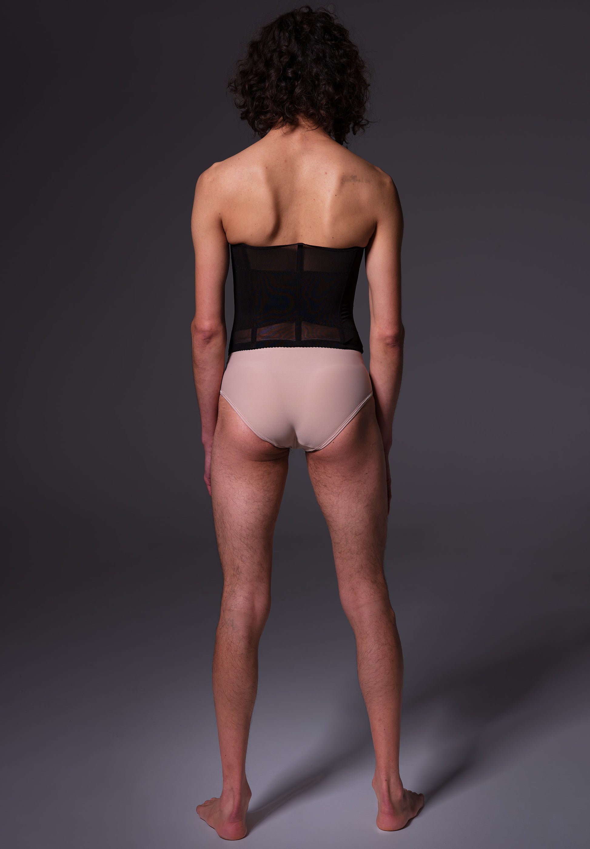 Riah is wearing the black corset, view from the back